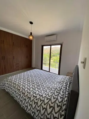 a bedroom with a large bed with a large window at Maria's Apartments 1 in Galata