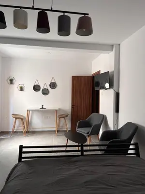 a bedroom with two chairs and a table at Maria's Apartment 2 in Galata