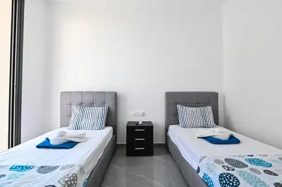 two beds sitting next to each other in a room at By the Beach Villa 12 in Protaras