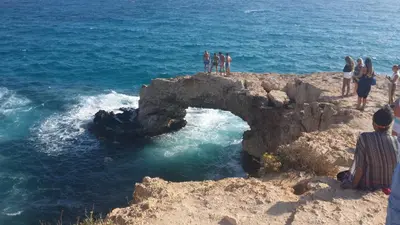 a group of people standing on top of a bridge in the ocean at Mythical Sands Resort Ilona Apartment for families in Protaras