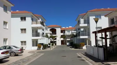 an empty street in front of some apartment buildings at Mythical Sands Resort Ilona Apartment for families in Protaras