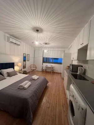 a large bedroom with a bed and a kitchen at RHEA Studio Down Town Nicosia in Nicosia