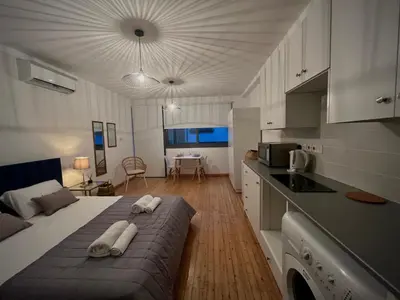 a bedroom with a large bed with towels on it at RHEA Studio Down Town Nicosia in Nicosia