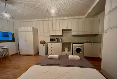 a kitchen with white cabinets and a washer at RHEA Studio Down Town Nicosia in Nicosia