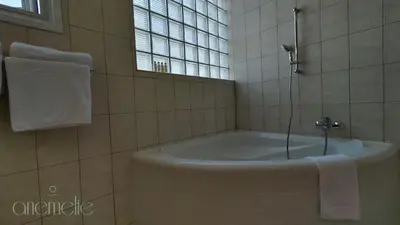 a bath tub in a bathroom with a window at anemelie in Sotira