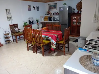 a dining room with a table and chairs and a kitchen at Traditional house in pelendri in Limassol