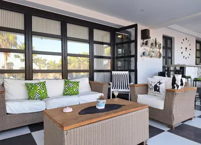 a living room with a white couch and a table at The Pervoli Studio - Pool - Close to Beach in Larnaka