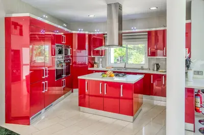 a red kitchen with red cabinets and a sink at Villa Amelia by Ezoria Villas in Pervolia