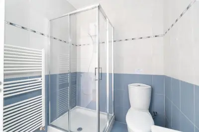 a bathroom with a toilet and a glass shower at Villa Amelia by Ezoria Villas in Pervolia
