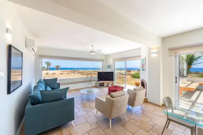 a living room with a view of the ocean at Protaras Seafront Villa Violetta in Protaras