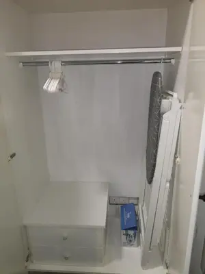a small white room with a closet with a shelf at Kalidonia “PANORAMA” STUDIO APARTMENT in Engomi