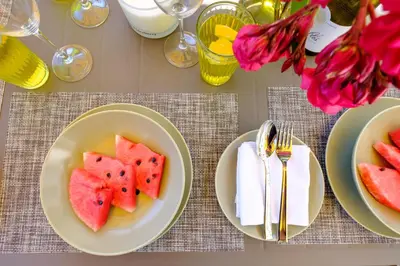 a table with two plates of watermelon on them at Pebble Beach Apartment in Voroklini