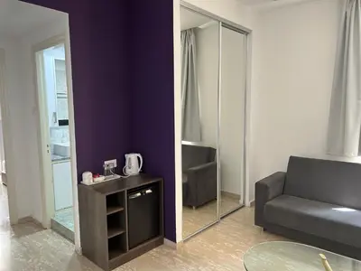 a living room with a couch and a mirror at St Elena Boutique Residence in Larnaka