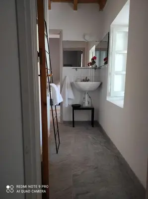 a bathroom with a sink and a mirror and a white sink at Ample Places in Pano Lefkara