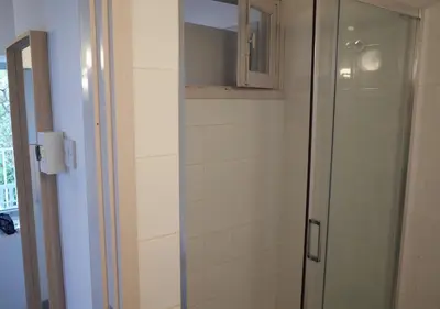 a bathroom with a shower with a glass door at Ample Places in Pano Lefkara