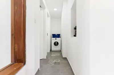 a hallway with a washing machine in a white room at To Hani - Large Traditional House in Nicosia