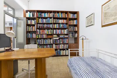 a room with a book shelf filled with books at To Hani - Large Traditional House in Nicosia