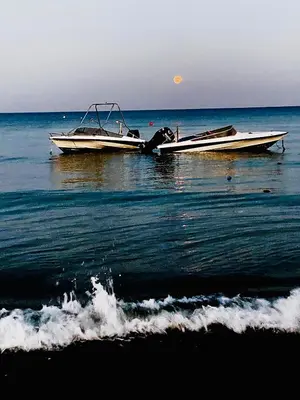 two boats sitting in the water on the beach at BALI SUITES 303 in Larnaka