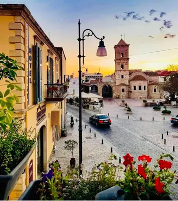 a view of a street with a church and a car at BALI SUITES 303 in Larnaka