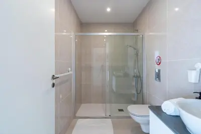 a bathroom with a shower and a toilet and a sink at Harmonia 2-BR Apt in Livadia in Larnaka