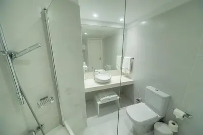 a bathroom with a toilet and a sink and a shower at MARGADINA HOTEL in Ayia Napa