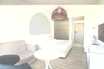 a living room with a white couch and a table at MARGADINA HOTEL in Ayia Napa