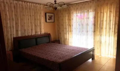 a bedroom with a bed and a window with curtains at 2 bedroom with private garden, walk to Nissi Beach, communal swimming pool in Ayia Napa