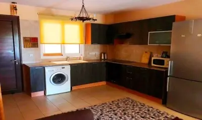 a kitchen with a washer and a dishwasher at 2 bedroom with private garden, walk to Nissi Beach, communal swimming pool in Ayia Napa