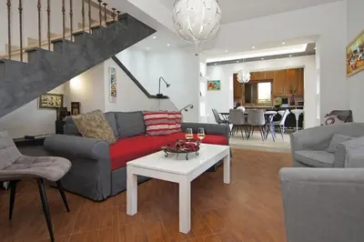 a living room with a couch and a table at Villa Polina in Ayia Napa