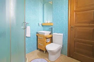 a bathroom with a toilet and a sink and a shower at Villa Polina in Ayia Napa