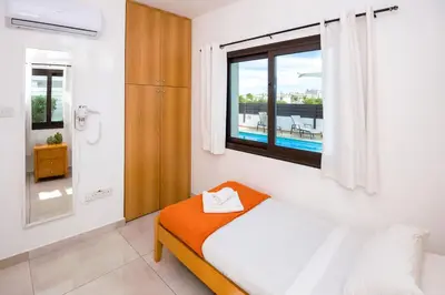 a bedroom with a bed and a window at Villa Abdera - 4bed with Private Pool in Protaras
