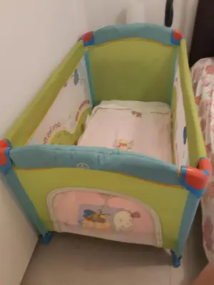 a toddler bed with a crib in a room at Beautiful apartment near beach in Larnaca in Scala