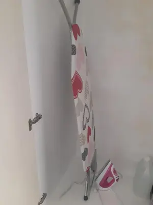 a surfboard is leaning against a wall at Beautiful apartment near beach in Larnaca in Scala