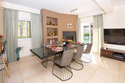 a dining room with a glass table and chairs at Villa Emily in Protaras