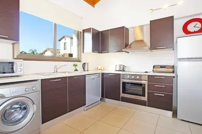 a kitchen with a washing machine and a dishwasher at Villa Louisa in Ayia Napa