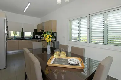 a kitchen and dining room with a table and chairs at Villa Palm in Protaras
