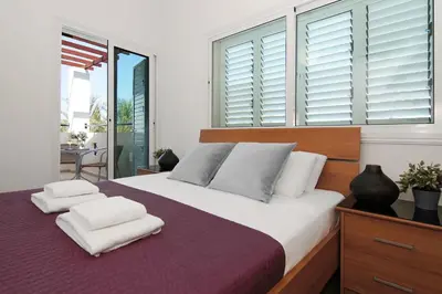 a bedroom with a large bed with two pillows on it at Villa Palm in Protaras