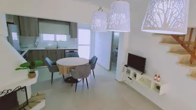 a kitchen and dining room with a table and chairs at STAY Melissa Villa in Protaras