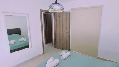 two pink slippers are sitting in a room with a mirror at STAY Melissa Villa in Protaras
