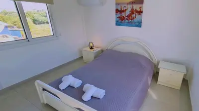 a bedroom with a bed with towels on it at STAY Melissa Villa in Protaras
