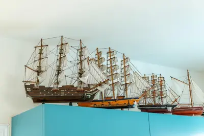 three model ships on a shelf on a wall at Protaras Villa Dafni in Protaras