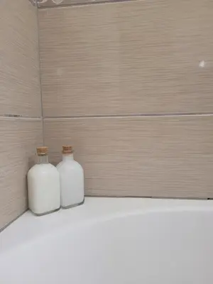 two white vases sitting on a shelf in a bathroom at Cielo Apartment in Ayia Napa