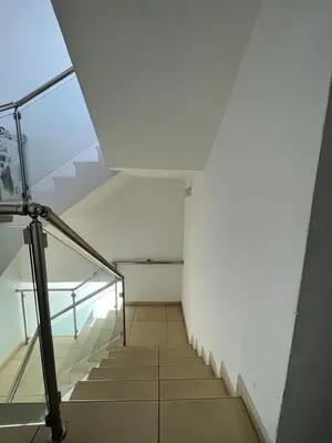 a stairway in a building with a glass railing at Cielo Apartment in Ayia Napa
