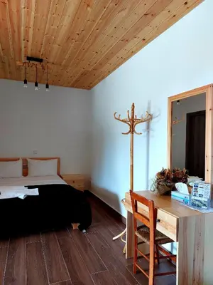 a bedroom with a bed and a cross on the wall at Agros Green Valley Suites in Limassol