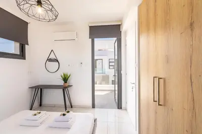 a room with white walls and a wooden door at Alasia Villas in Paralimni