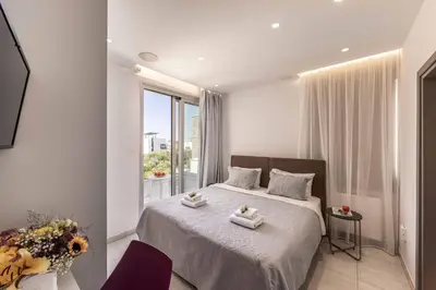 a bedroom with a bed with towels on it at Villa Green Haven 2 Protaras Cyprus in Protaras