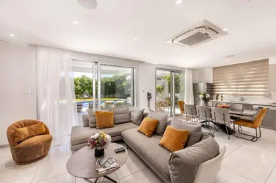 a living room with a couch and a table at Villa Green Haven 2 Protaras Cyprus in Protaras