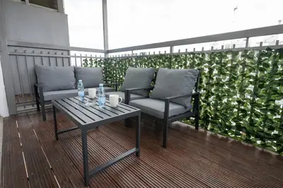 a pair of chairs and a table on a balcony at Napa Centrale Suites in Ayia Napa