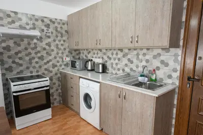 a kitchen with a sink and a washing machine at Napa Centrale Suites in Ayia Napa