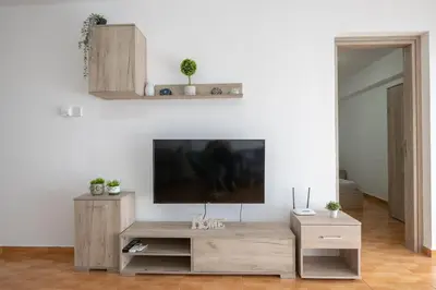 a living room with a flat screen tv on a white wall at Napa Centrale Suites in Ayia Napa